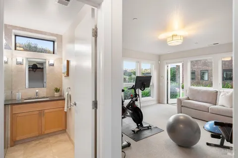 a view of a balcony with floor to ceiling windows with wooden fence