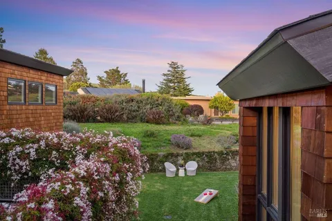 an aerial view of a house with a yard