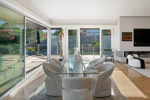 a living room with fireplace furniture and a floor to ceiling window