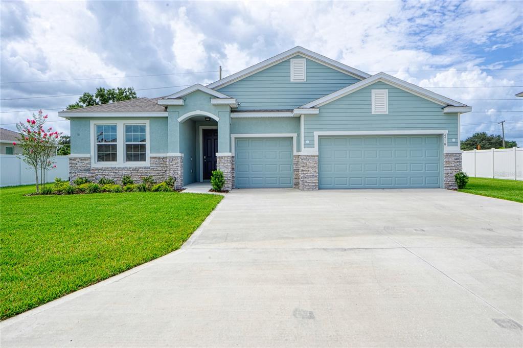 4710 Southwest 65th Place Ocala, FL 34474 - Photo 1 of 1 a front view of a house with a garden and yard