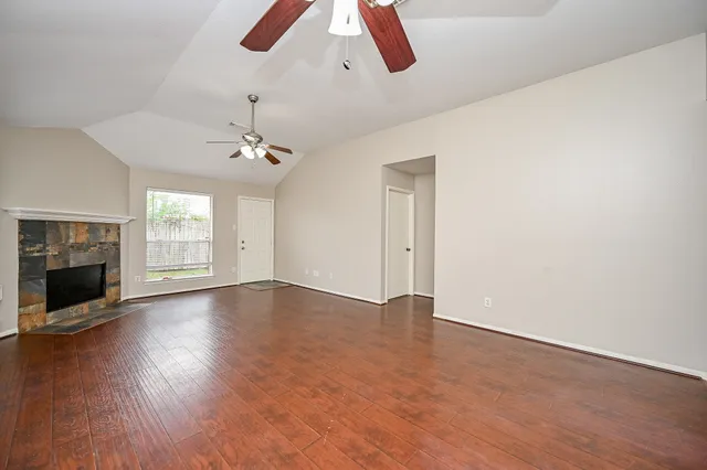 wooden floor in an empty room with a fireplace