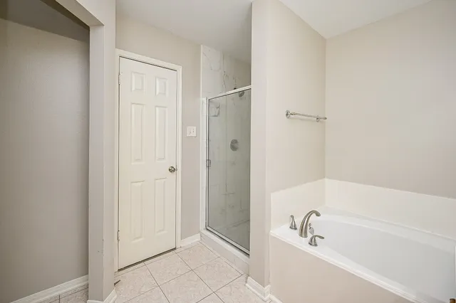 a bathroom with a bathtub and a shower