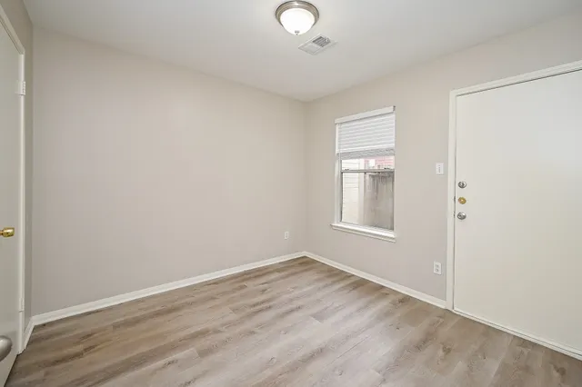 a view of a livingroom with wooden floor and a window