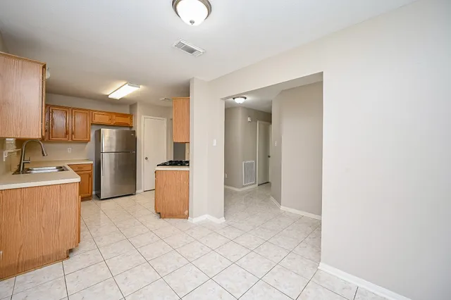 a kitchen with a refrigerator and a sink