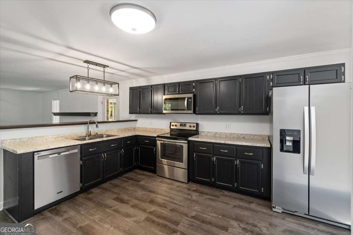 148 Bunker Drive Athens, GA 30607 - Photo 12 of 38 a kitchen with stainless steel appliances granite countertop a stove sink and refrigerator