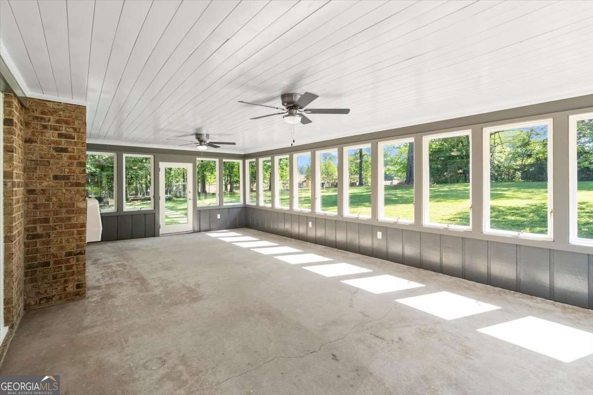 148 Bunker Drive Athens, GA 30607 - Photo 17 of 38 a view of an empty room with a fireplace and a large window