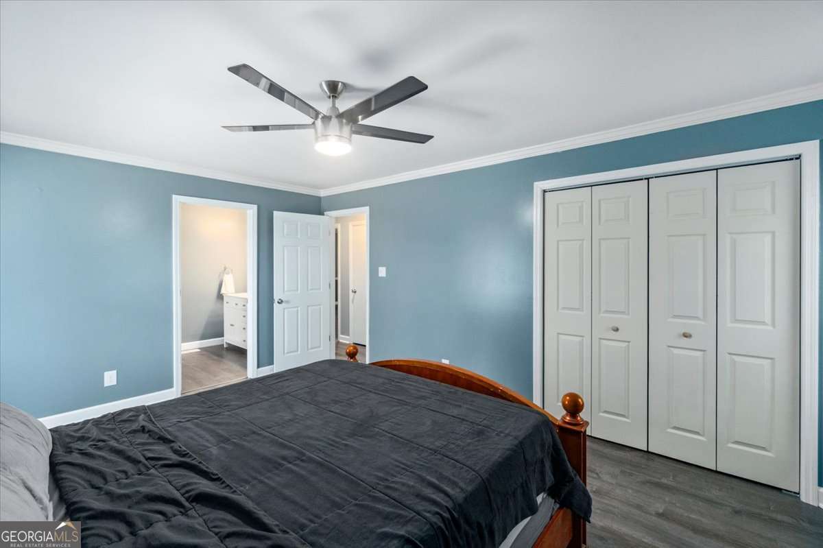 148 Bunker Drive Athens, GA 30607 - Photo 26 of 38 a bedroom with a large bed and a chandelier fan