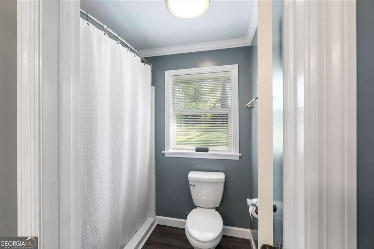 148 Bunker Drive Athens, GA 30607 - Photo 28 of 38 a bathroom with a toilet a sink and a window