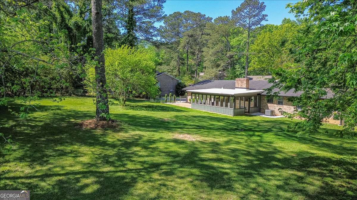 148 Bunker Drive Athens, GA 30607 - Photo 3 of 38 a view of a house with a big yard and large trees