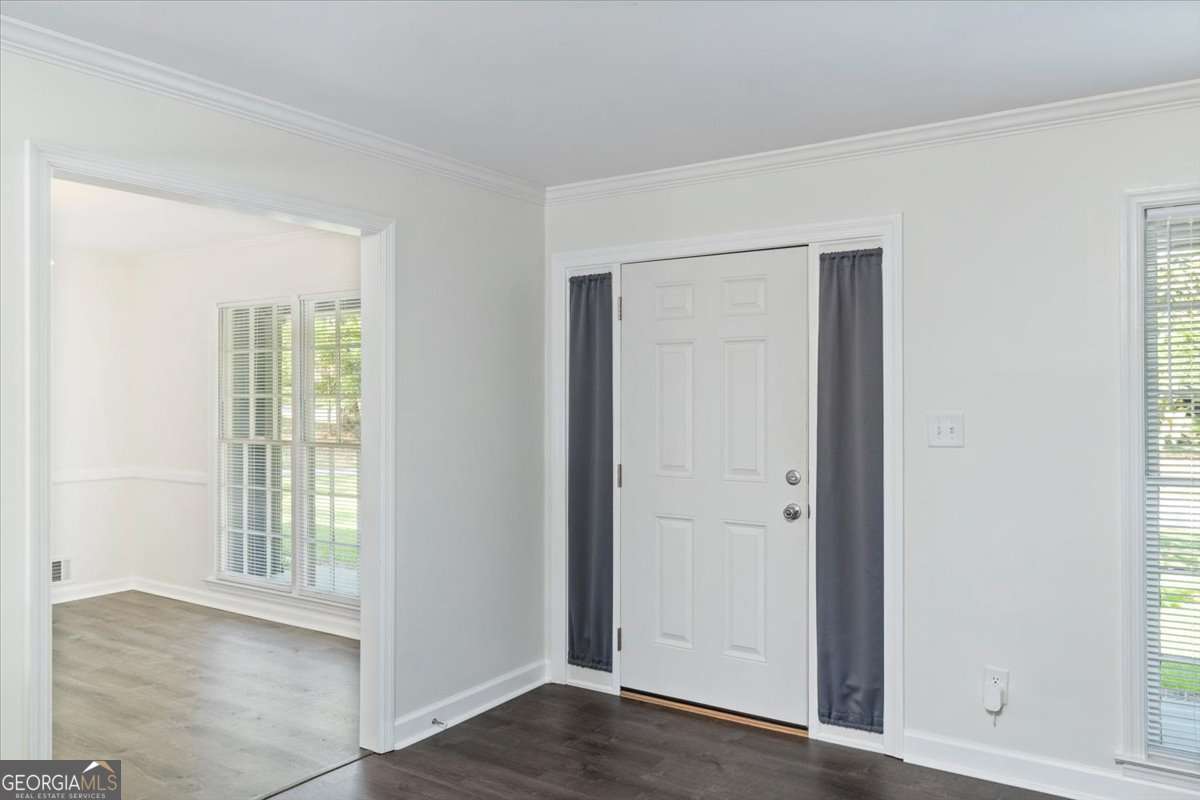 148 Bunker Drive Athens, GA 30607 - Photo 6 of 38 a view of an empty room with wooden floor and a window