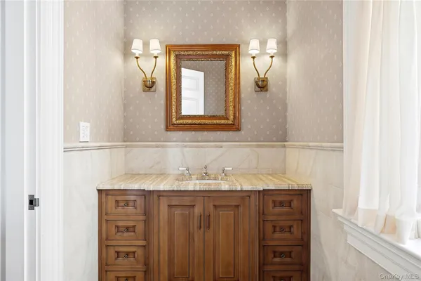 a bathroom with a granite countertop sink and a mirror