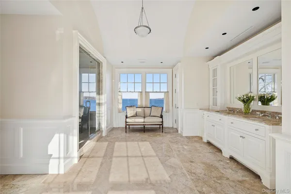 a spacious en suite bathroom with a granite countertop tub and shower