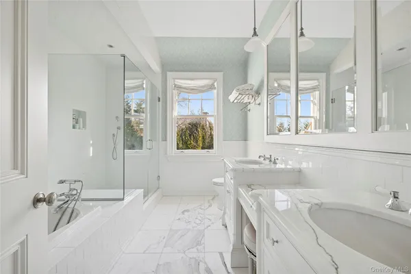 a bathroom with a tub sink and mirror