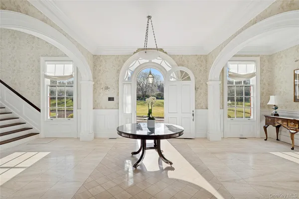a living room with furniture and a large mirror