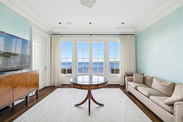 a view of an empty room with wooden floor and cabinet