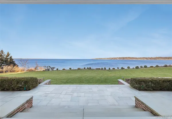 a view of a house with a yard and sitting area