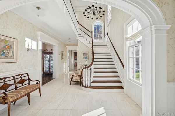 a view of entryway with furniture and wooden floor