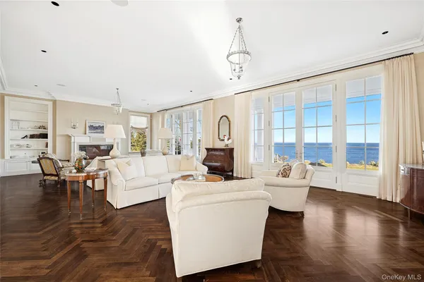 a living room with fireplace furniture and a large window