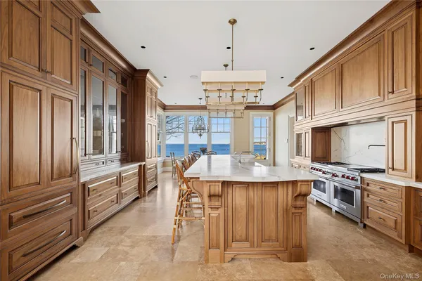 a large kitchen with stainless steel appliances granite countertop a stove and a sink