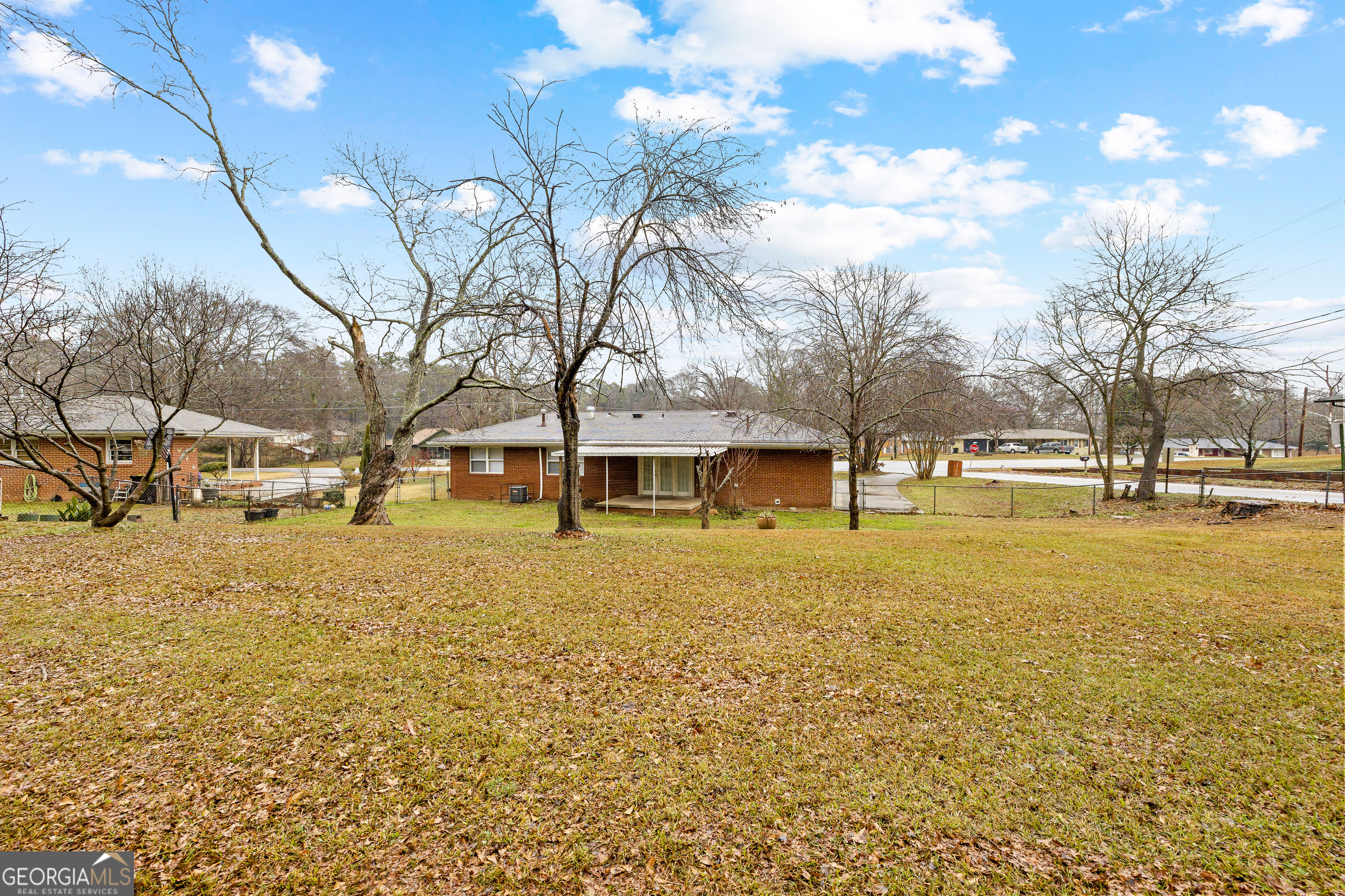 257 Fayetteville Road Fairburn, GA 30213 - Photo 29 of 31 a yellow house with trees in front of it