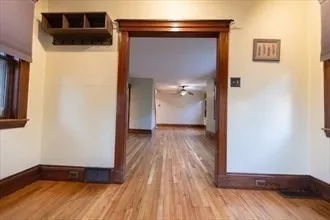 a view of a hallway with wooden floor and closet