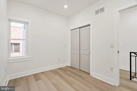 an empty room with wooden floor