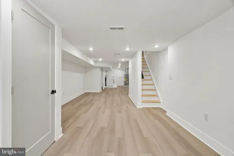 a view of a big room with wooden floor and a window