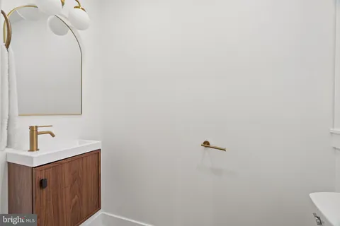 a view of a kitchen with kitchen island a sink and wooden floor