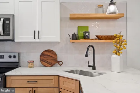 a kitchen with a refrigerator stove and sink