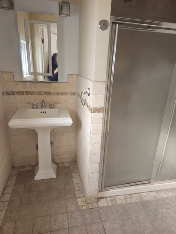 a bathroom with a sink a mirror and shower