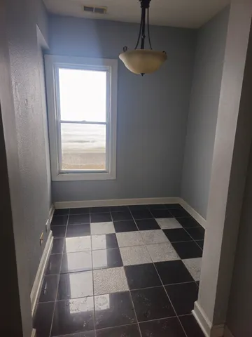 a view of an empty room with a window