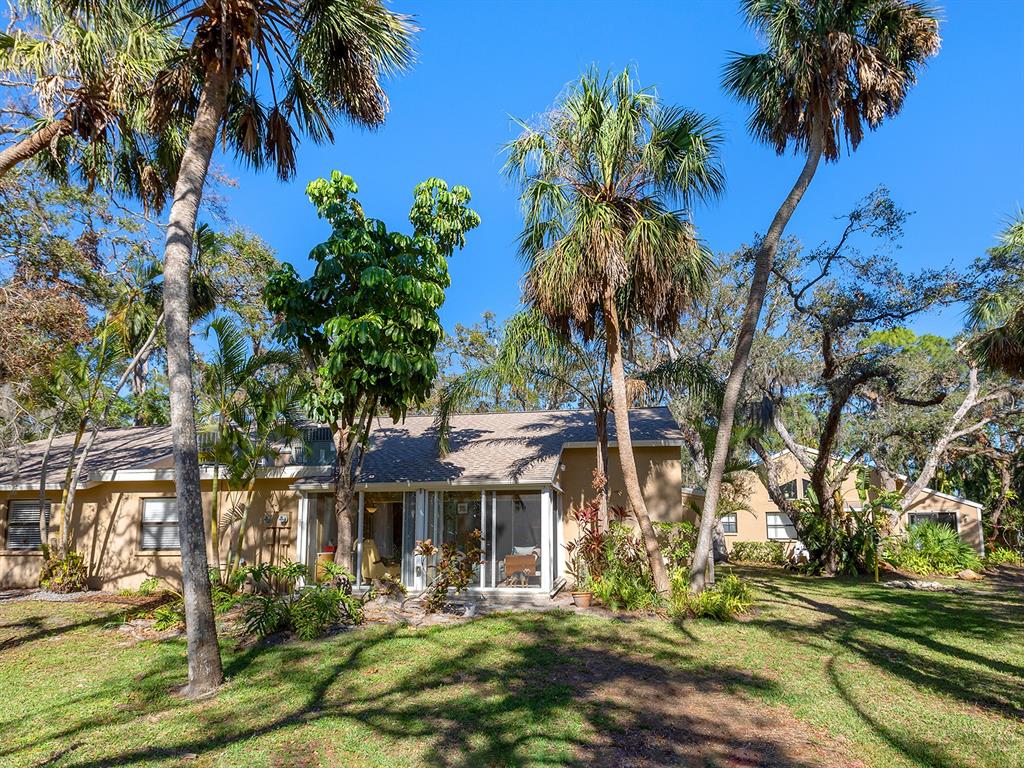 4869 Village Gardens Drive, Unit 189 Sarasota, FL 34234 - Photo 1 of 28 a front view of a house with garden