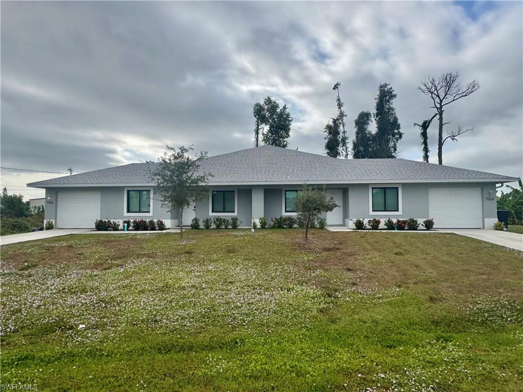 7066 Babcock Road Fort Myers, FL 33967 - Photo 1 of 15 a front view of a house with a garden