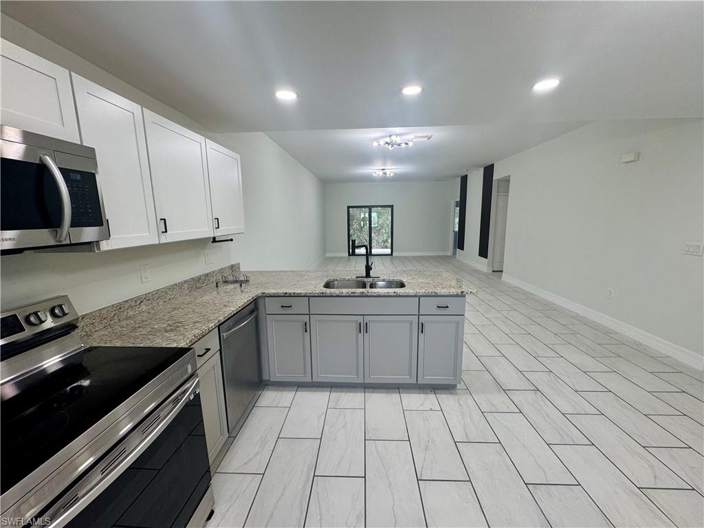 7066 Babcock Road Fort Myers, FL 33967 - Photo 5 of 15 a kitchen with a sink stove and cabinets