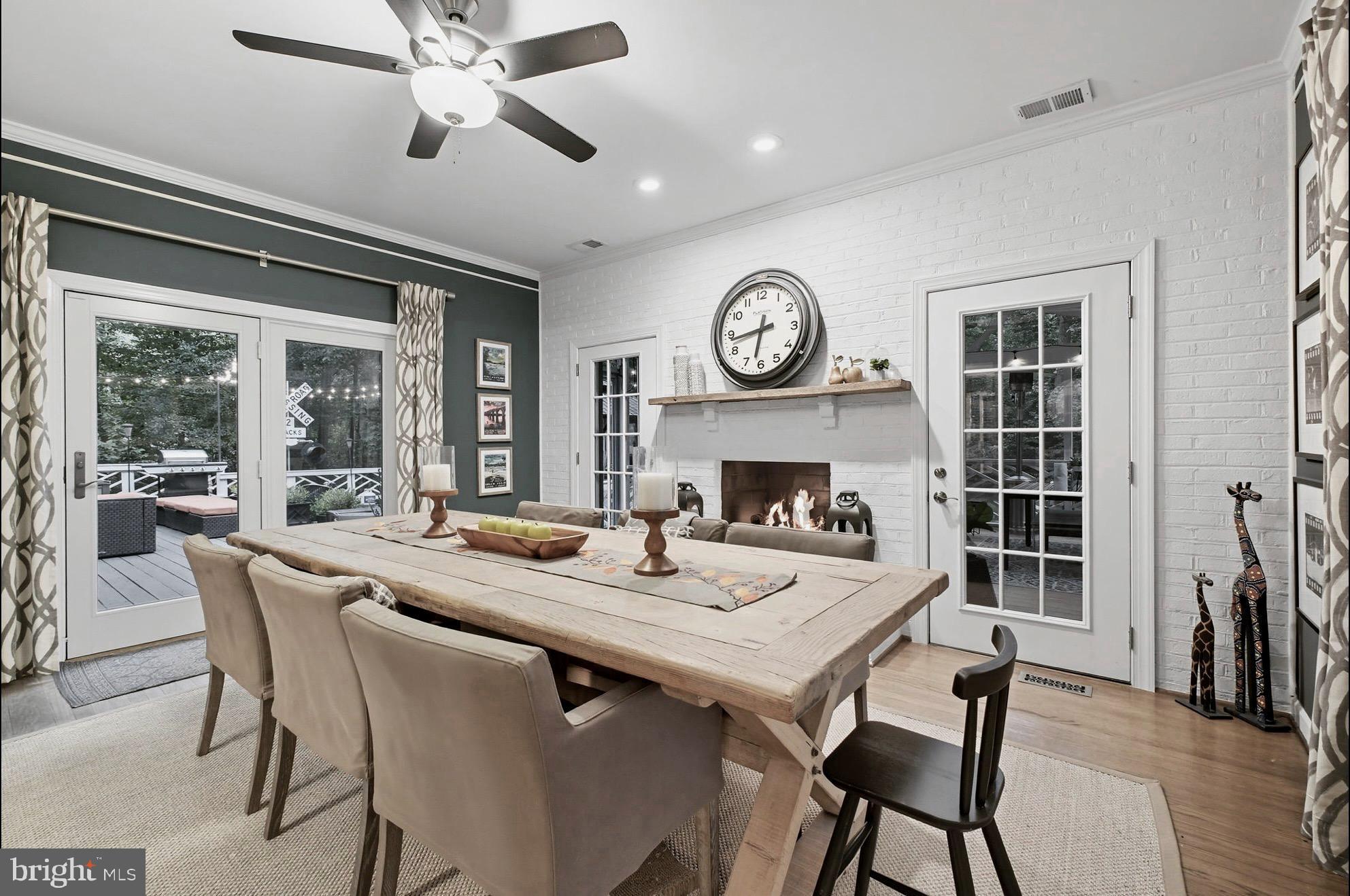 9217 Jeffery Road Great Falls, VA 22066 - Photo 24 of 80 a dining room with wooden floor a chandelier a wooden table and chairs