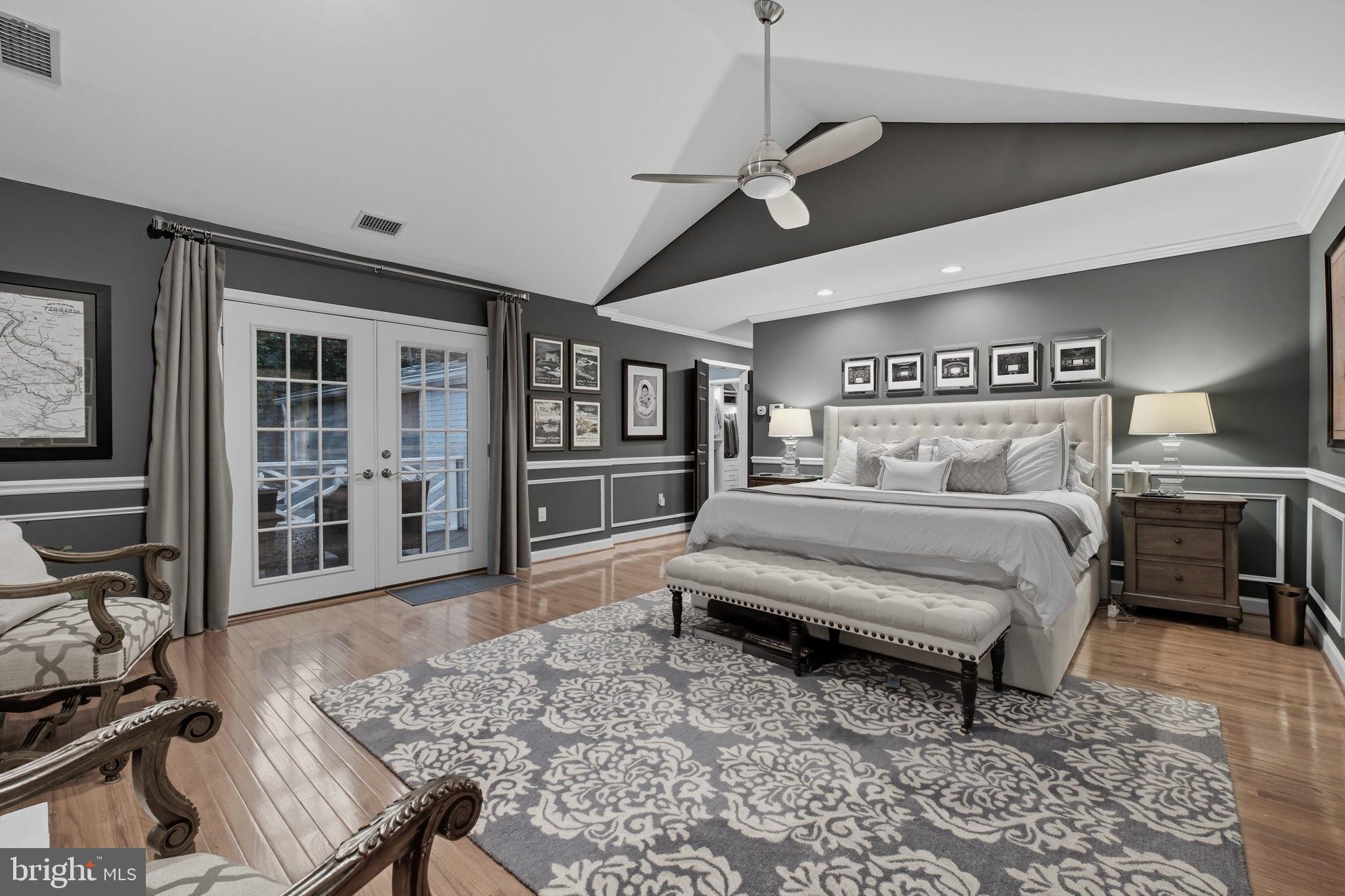 9217 Jeffery Road Great Falls, VA 22066 - Photo 35 of 80 a bedroom with a bed wooden floor and view of kitchen