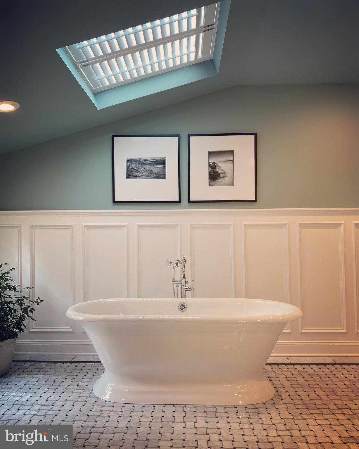 9217 Jeffery Road Great Falls, VA 22066 - Photo 39 of 80 a white tub sitting next to a white wooden cabinet