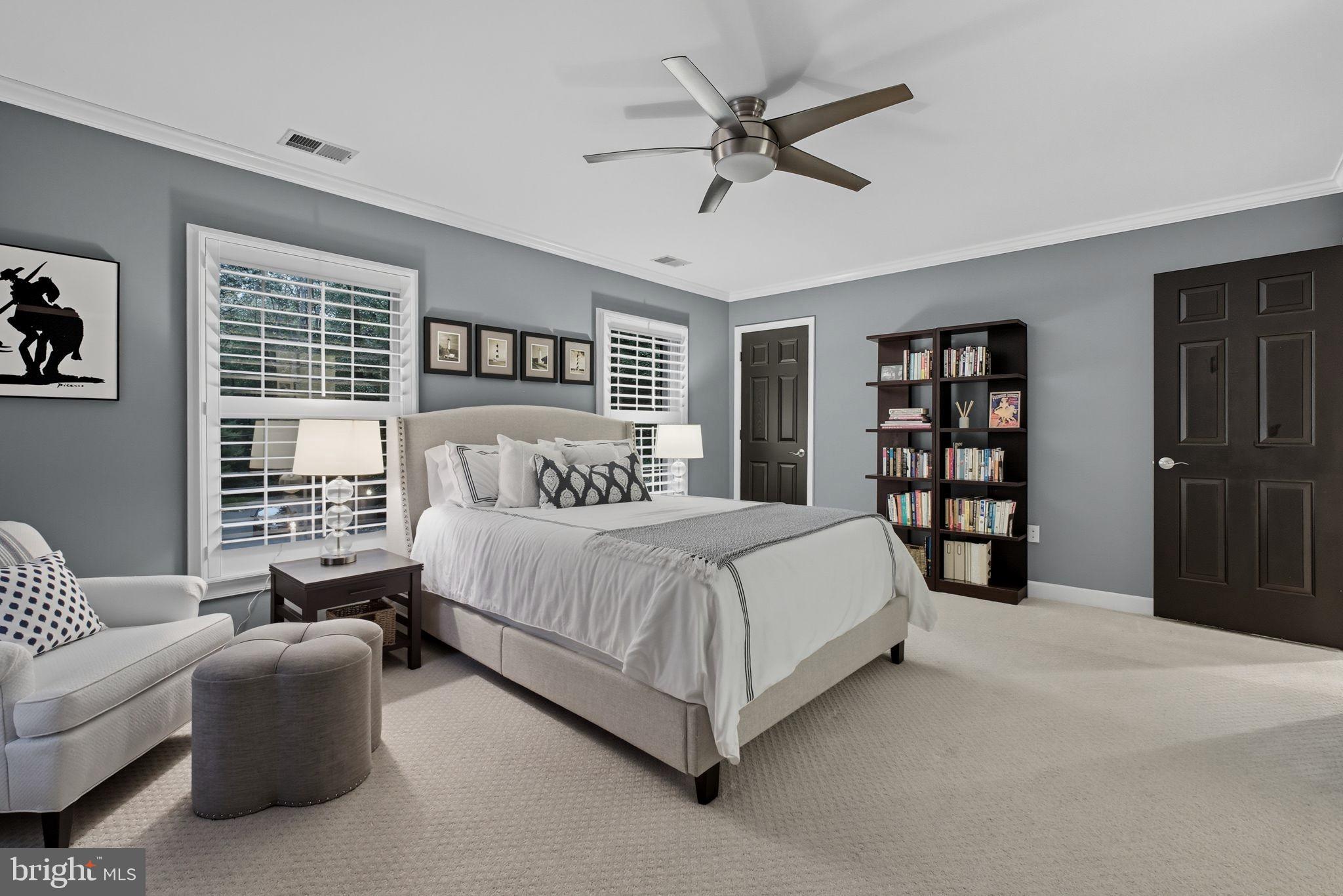 9217 Jeffery Road Great Falls, VA 22066 - Photo 45 of 80 a spacious bedroom with a large bed and a couch