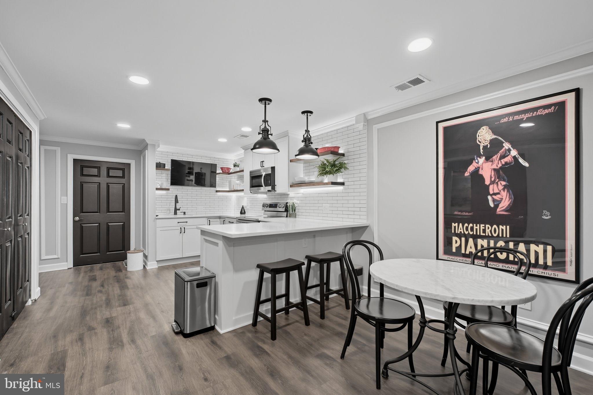 9217 Jeffery Road Great Falls, VA 22066 - Photo 58 of 80 a large kitchen with a table and chairs