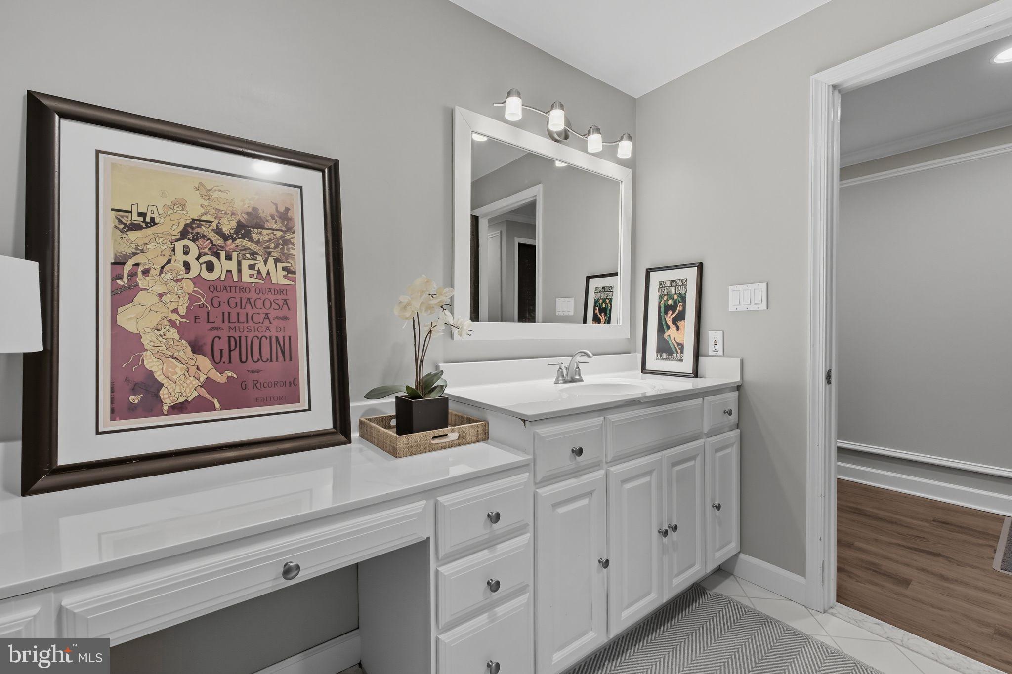 9217 Jeffery Road Great Falls, VA 22066 - Photo 64 of 80 a bathroom with double vanity sink and a mirror