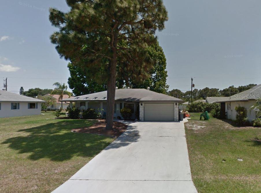7539 Ebro Road Englewood, FL 34224 - Photo 1 of 1 a front view of a house with a yard garage and trees