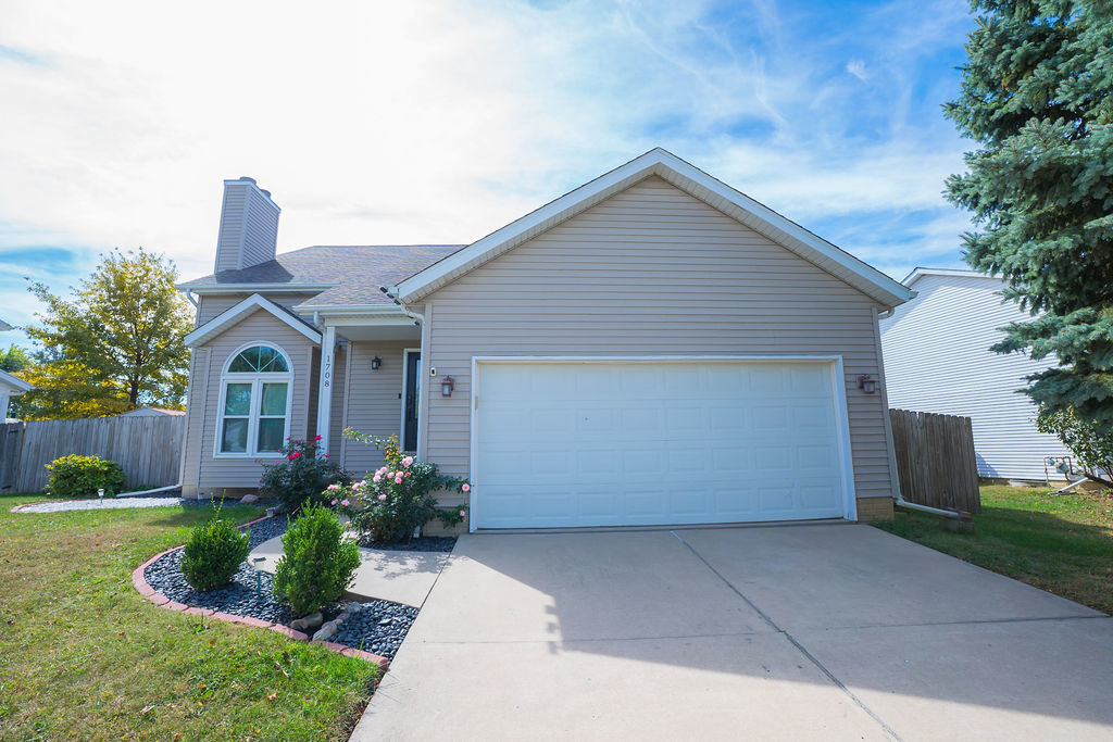 1708 Royal Pointe Drive Bloomington, IL 61704 - Photo 1 of 48 a front view of a house with garden