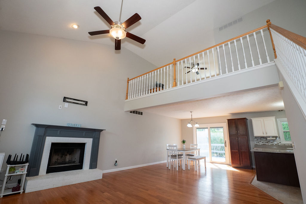 1708 Royal Pointe Drive Bloomington, IL 61704 - Photo 13 of 48 a very nice looking living room with wooden floor and a ceiling fan