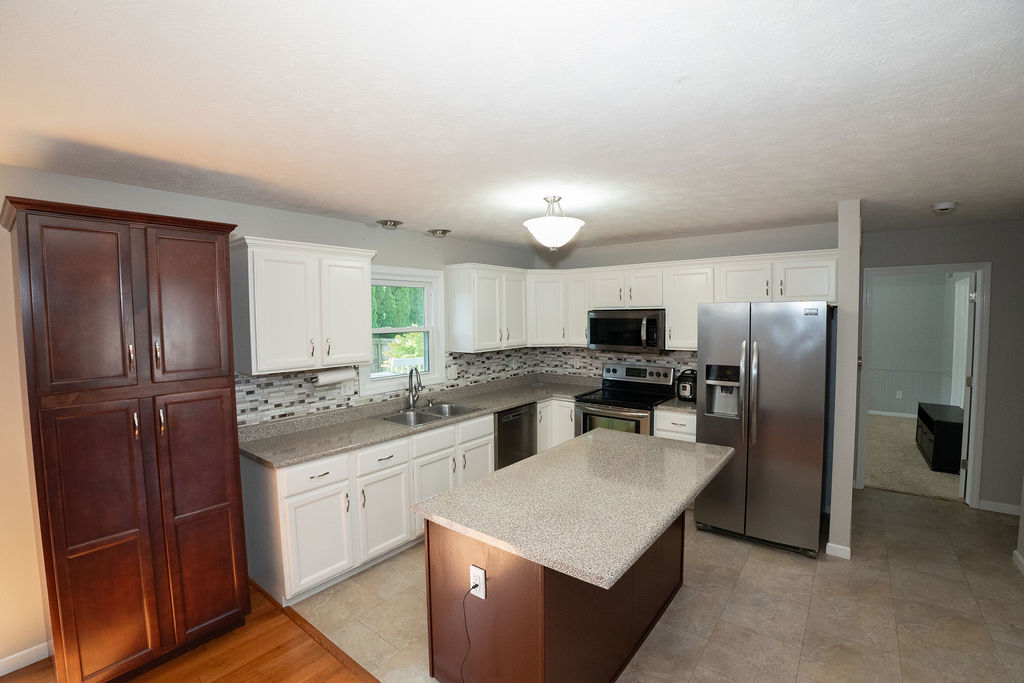 1708 Royal Pointe Drive Bloomington, IL 61704 - Photo 17 of 48 a kitchen with a refrigerator a sink and cabinets