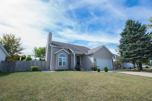 a front view of house with yard and trees