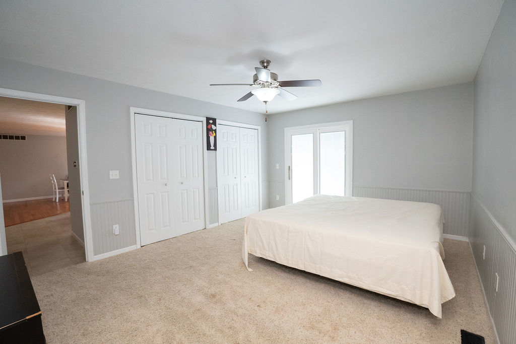 1708 Royal Pointe Drive Bloomington, IL 61704 - Photo 22 of 48 a bedroom with a bed and a chandelier