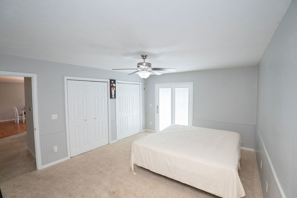 1708 Royal Pointe Drive Bloomington, IL 61704 - Photo 23 of 48 a bedroom with a large bed and a ceiling fan