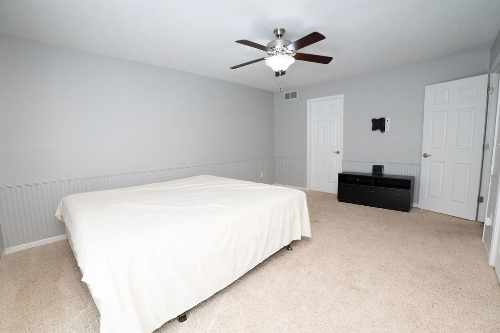 1708 Royal Pointe Drive Bloomington, IL 61704 - Photo 24 of 48 a spacious bedroom with a bed and a chandelier