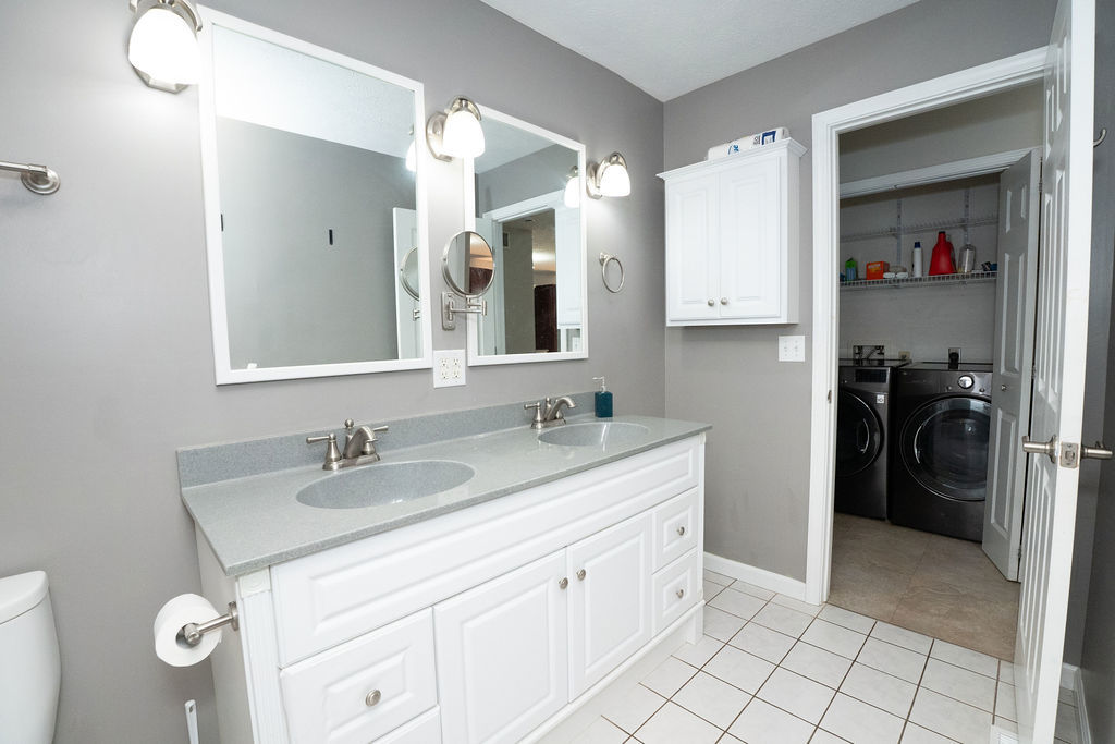 1708 Royal Pointe Drive Bloomington, IL 61704 - Photo 26 of 48 a bathroom with a sink double vanity and a mirror