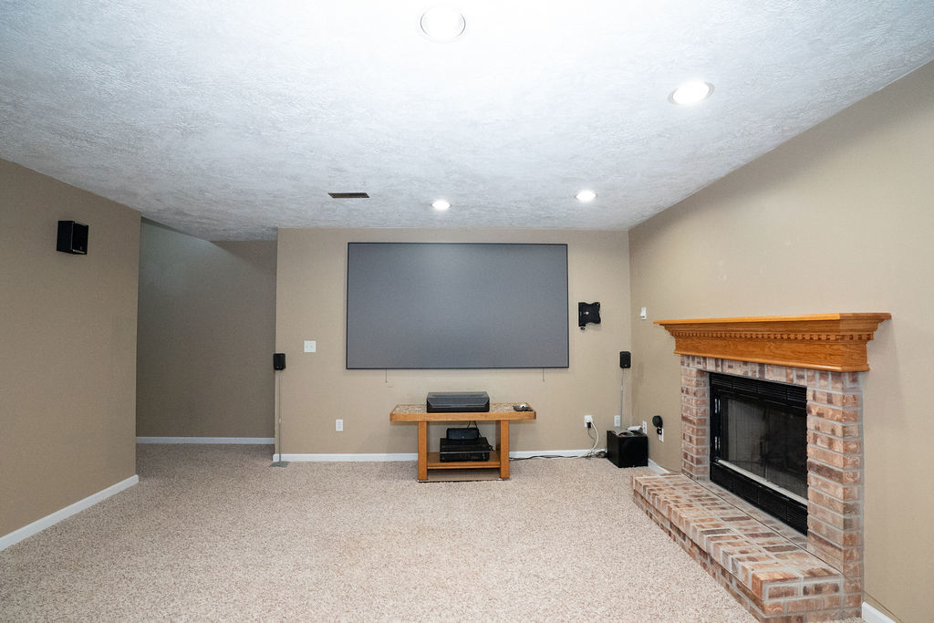 1708 Royal Pointe Drive Bloomington, IL 61704 - Photo 29 of 48 a living room with furniture a fireplace and a flat screen tv